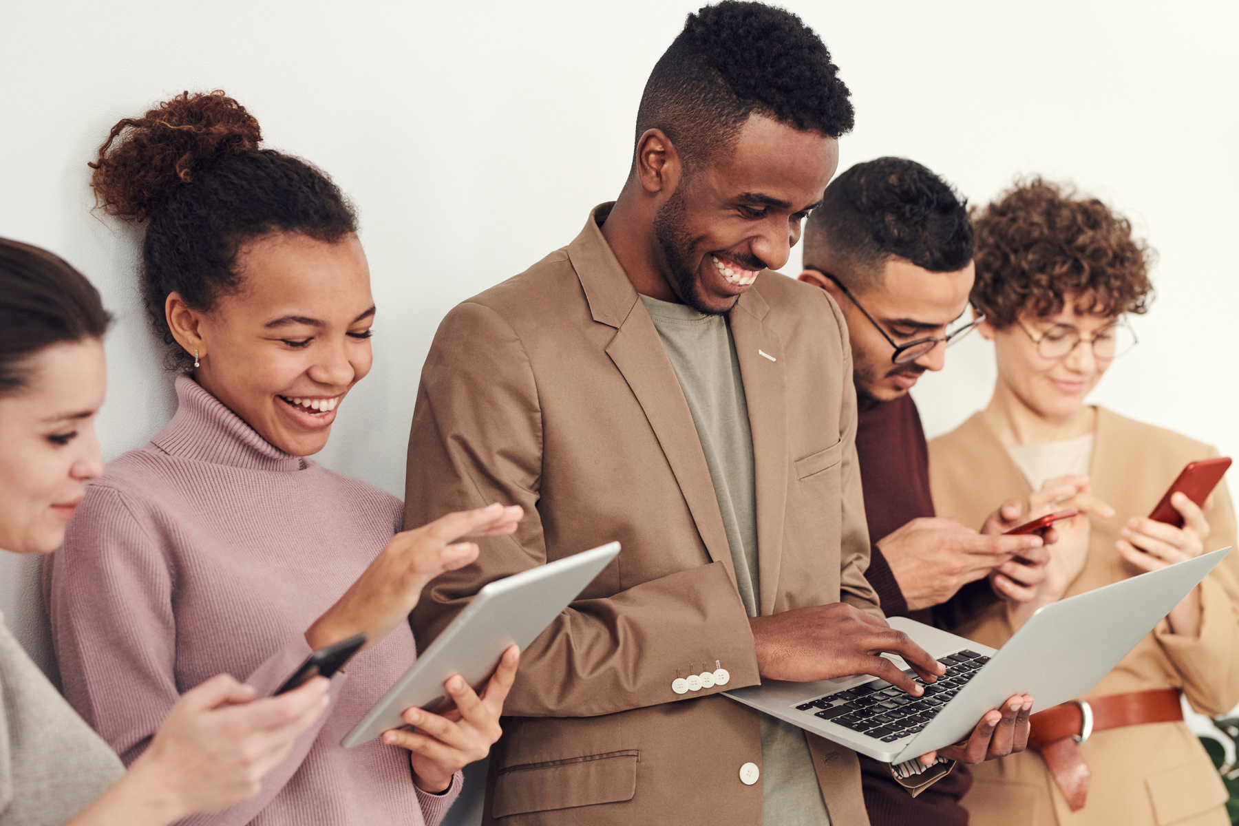 Young professionals using digital devices together