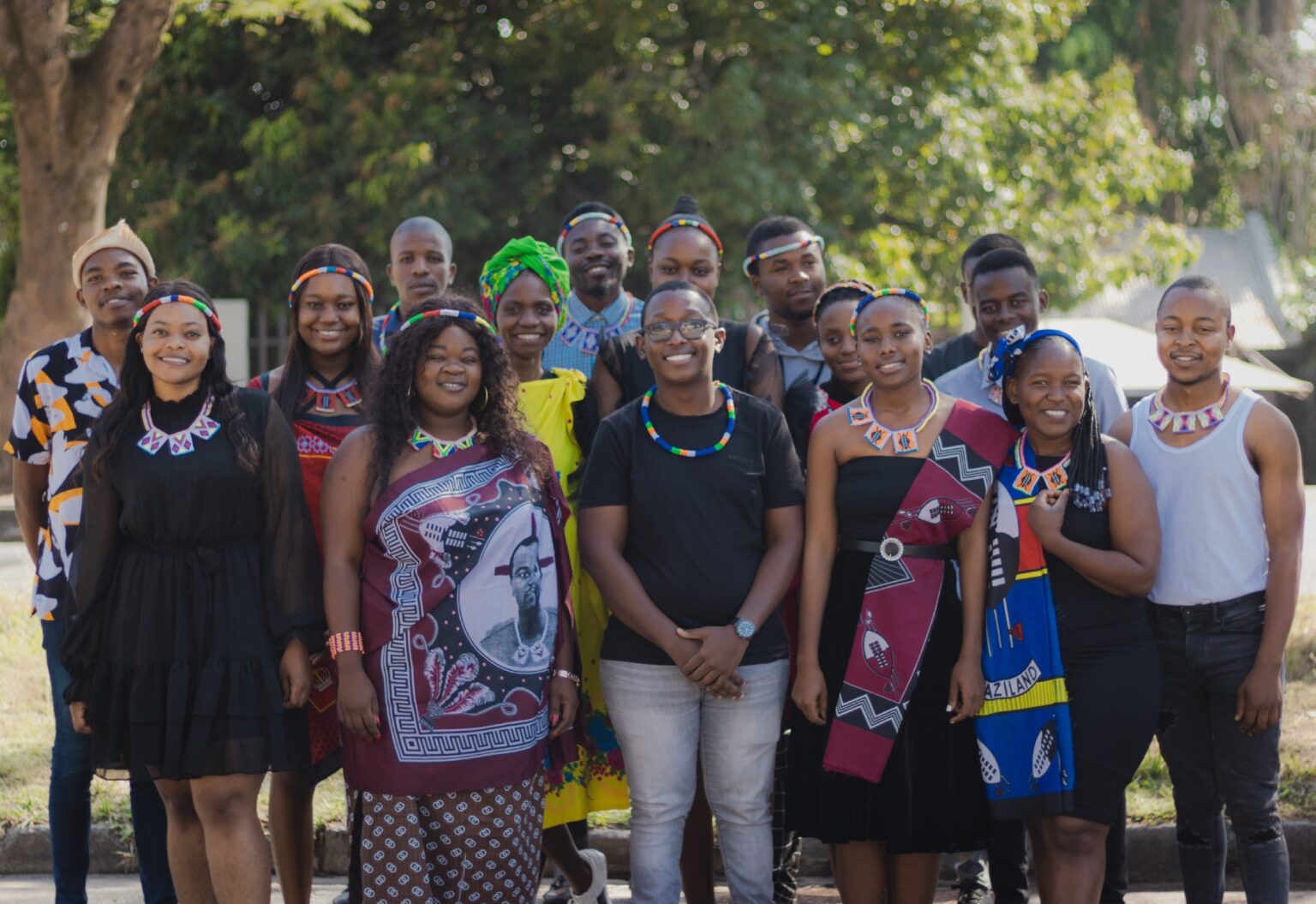 A diverse group of young people wearing colourful Southern African cultural attire